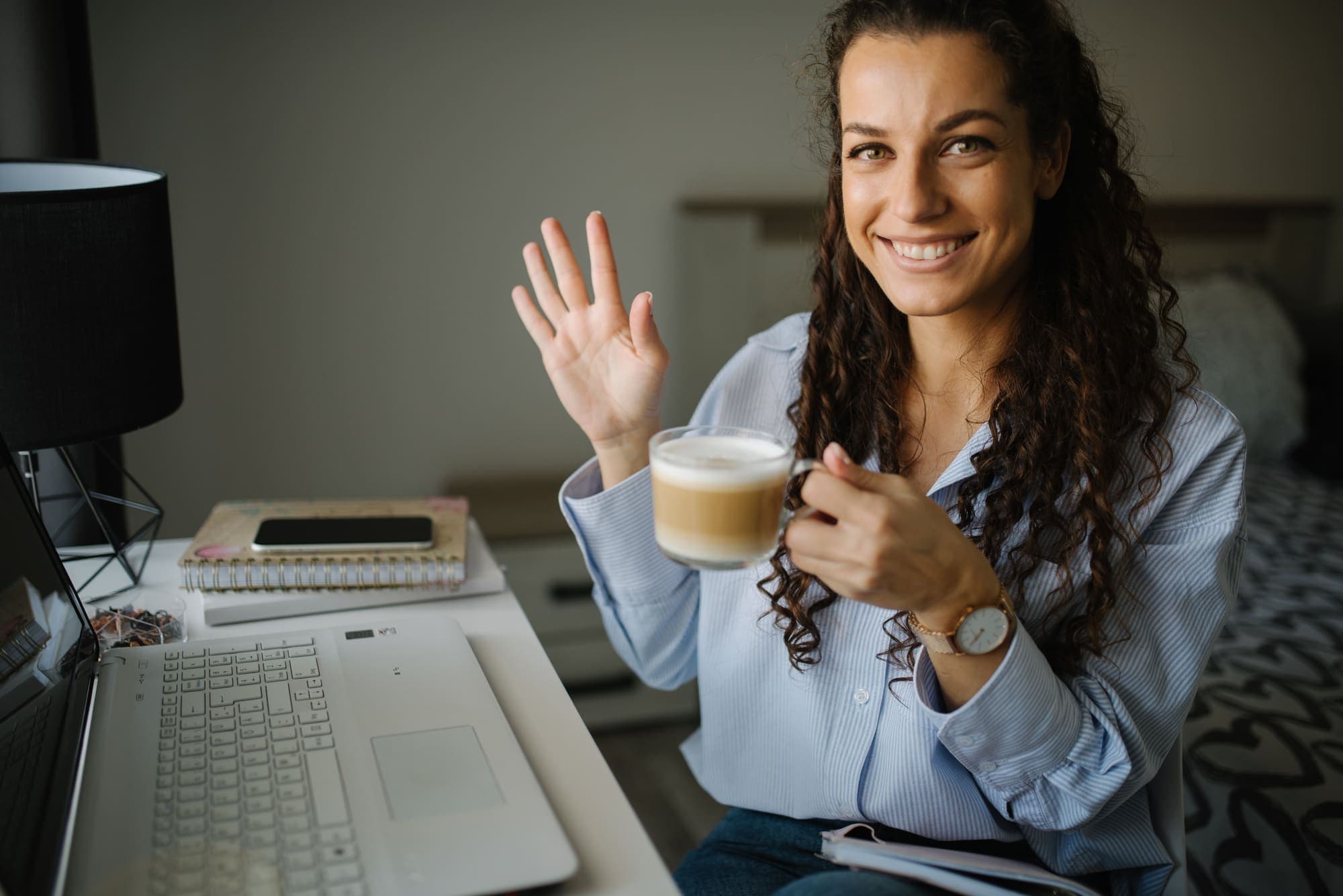 A smiling student at her laptop